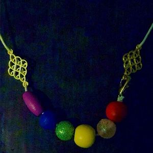 Hanfcrafted pride rope necklace with 18k gold pieces and beads.
